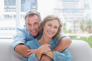 middle-aged couple smiling and hugging